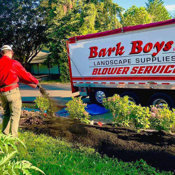 Bark Boys employee using express blower to spread bark dust quickly