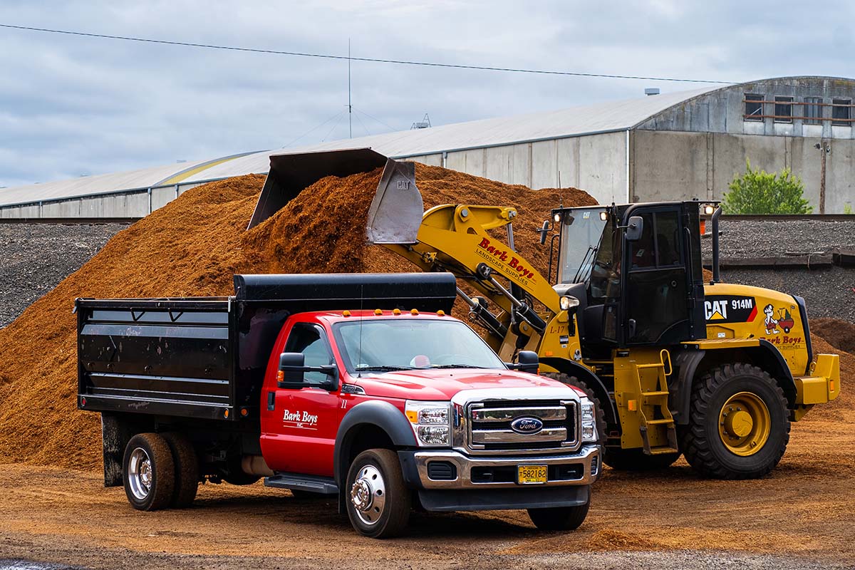 Bark Boys employee using express blower to spread bark dust quickly