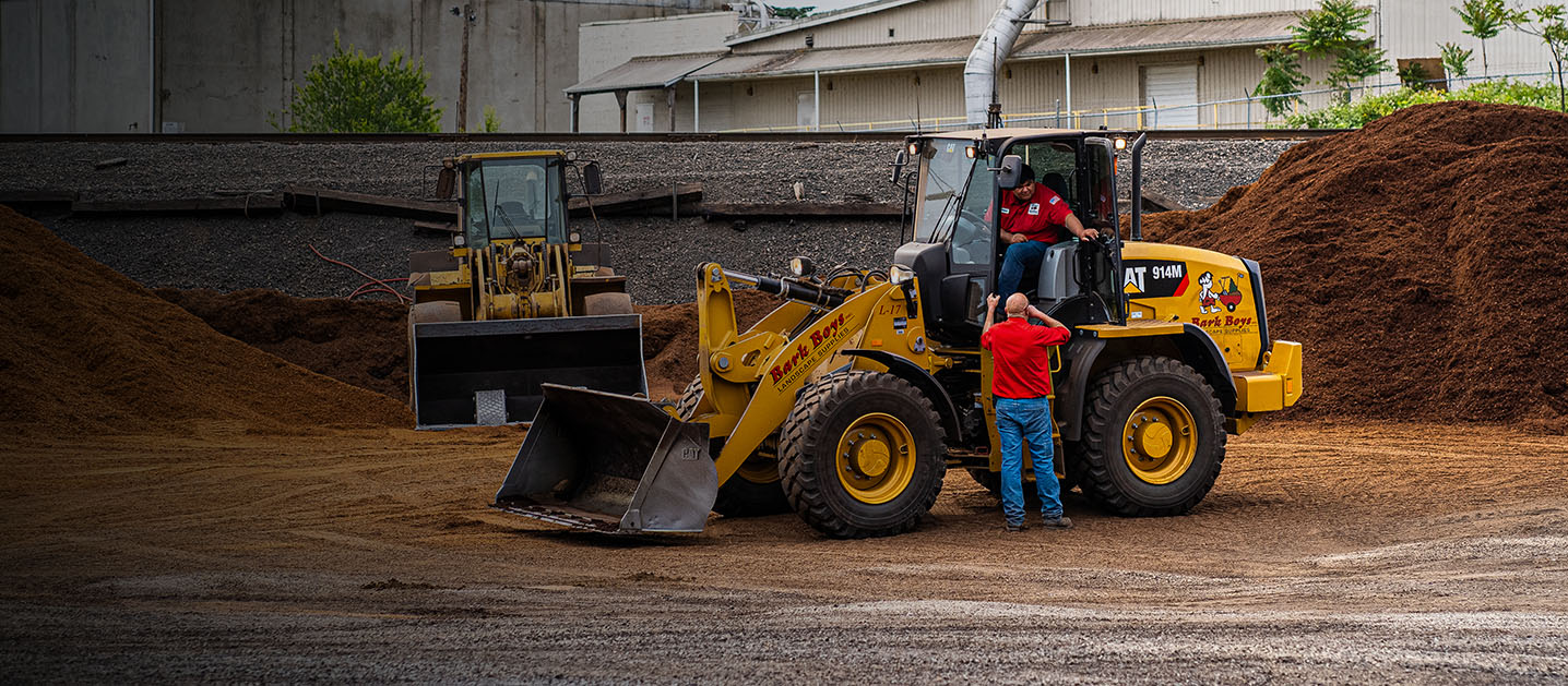 Bark Boys employees working on excavator